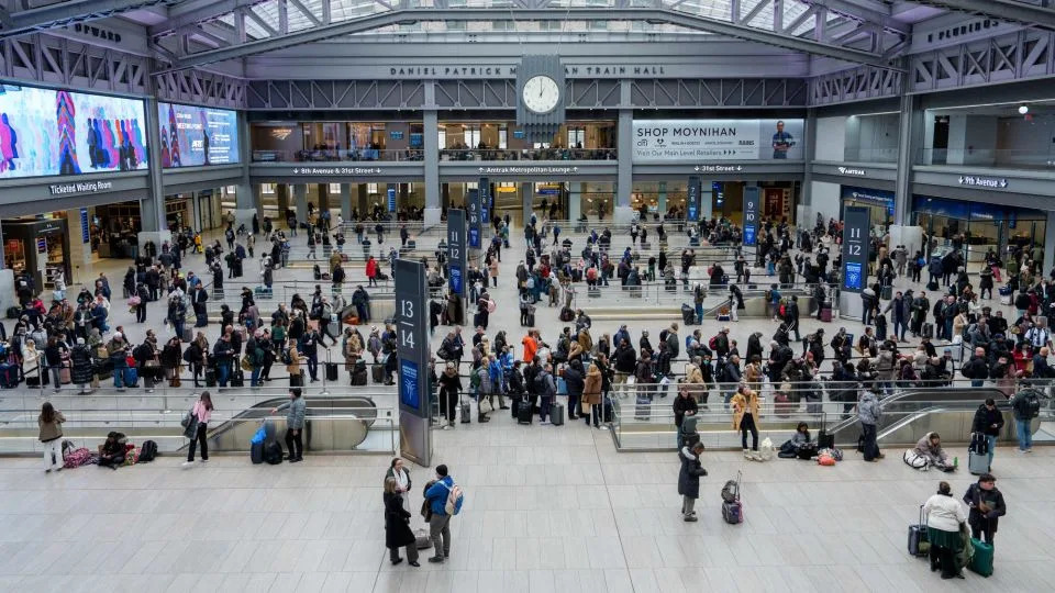 Travelers in Moynihan Train Hall at Penn Station in New York on January 23. - Adam Gray/Bloomberg/Getty Images/File