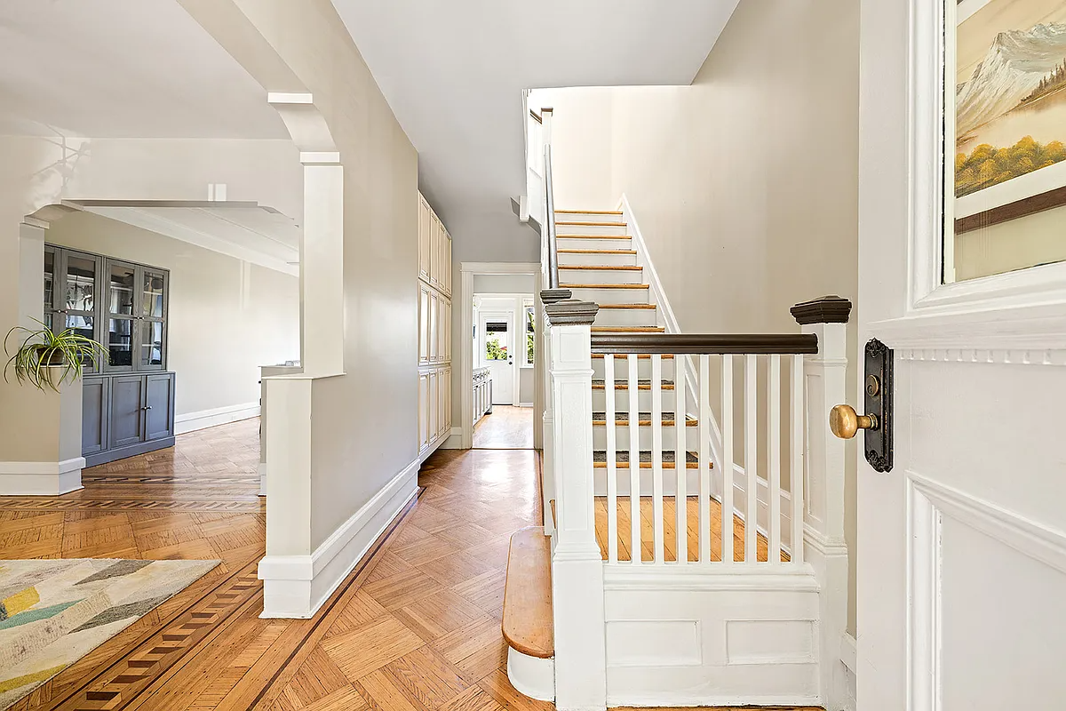 entry with wood floor, arched doorways