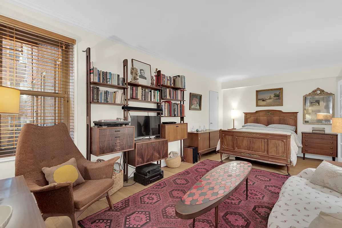 living space with seating area and a bed