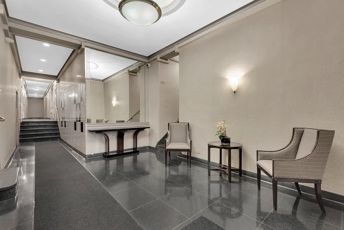 building lobby with tile floor, beige walls