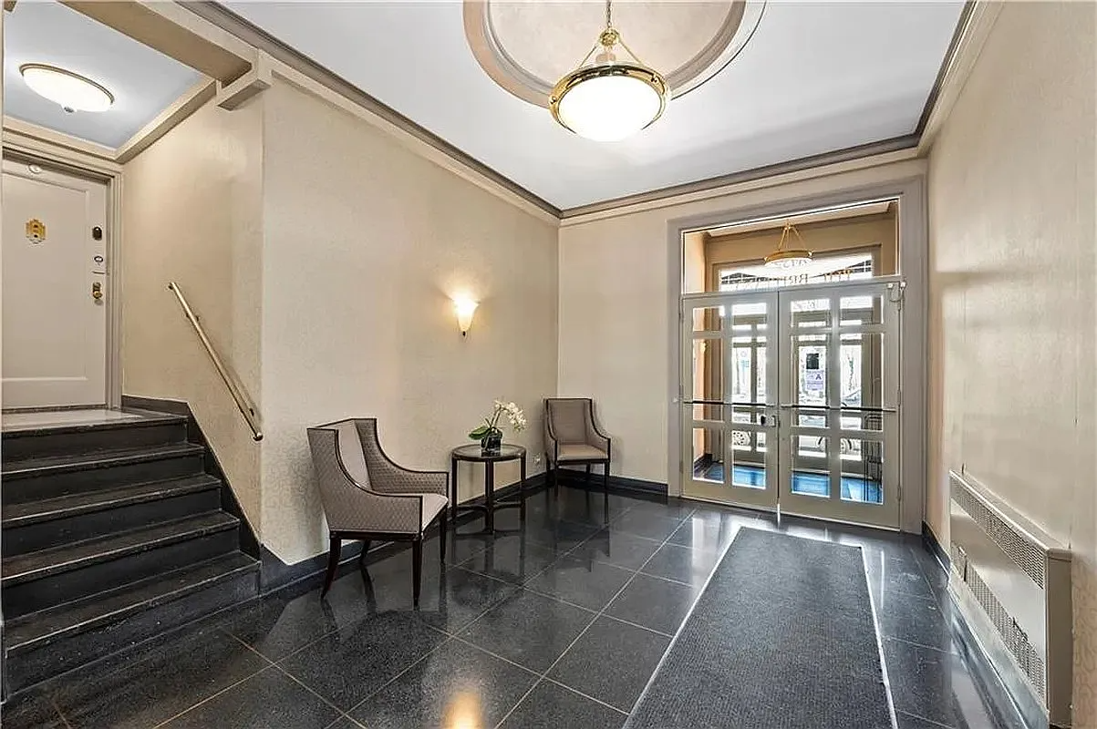 building lobby with tile floor, beige walls