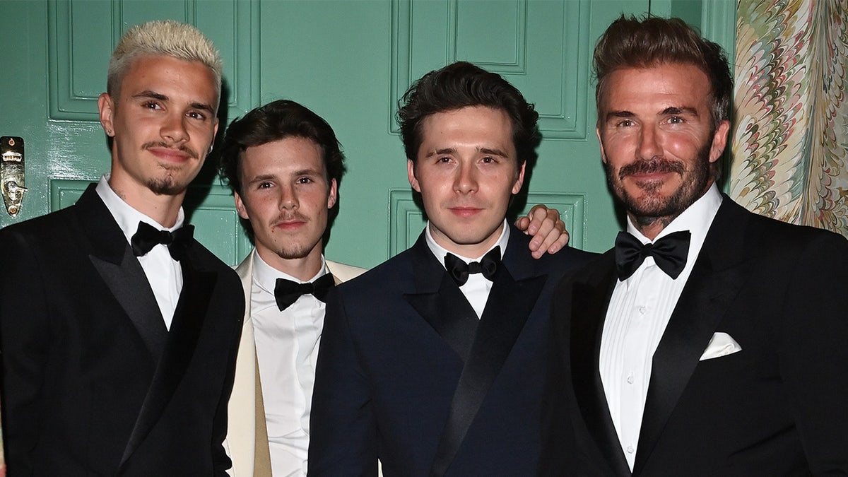 David Beckham poses with his sons in matching tuxedos