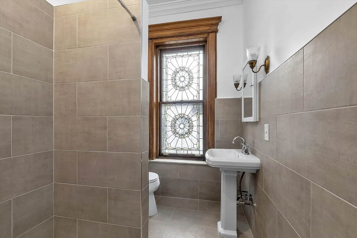 bathroom with stained glass window, modern beige tile