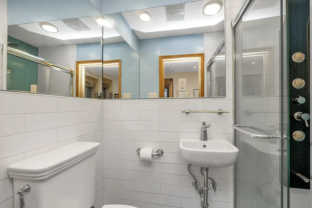 bath with shower and white fixtures