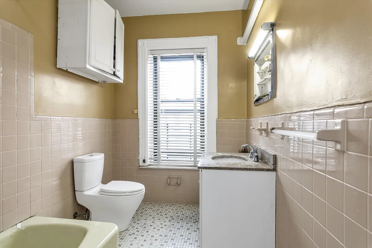 bathroom with mid century tiles, modern toilet 