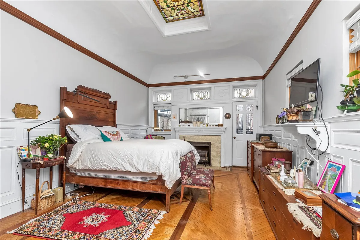 parlor level bedroom with white mantel