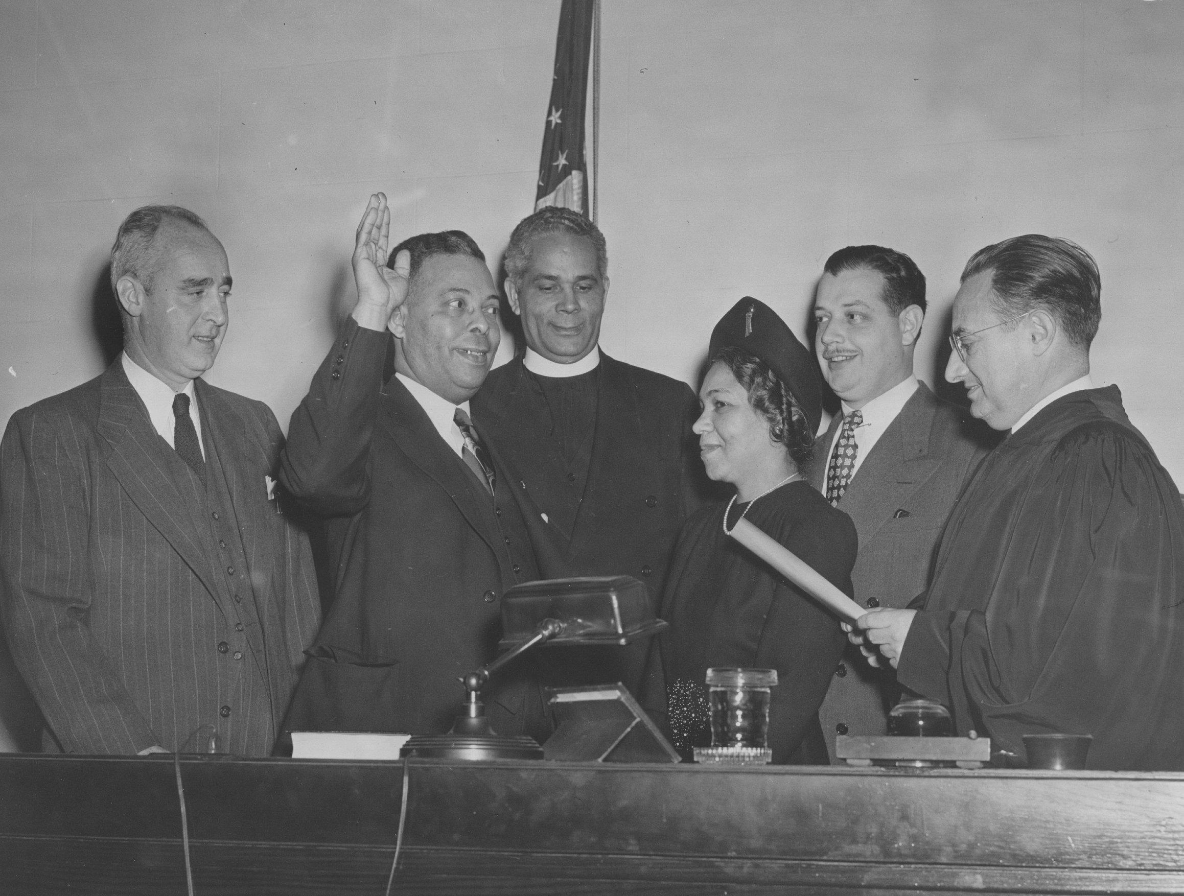 black and white photo of a group of people with bertram l baker raising his hand to take the oath of office