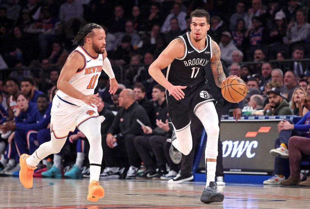 Brooklyn Nets forward Michael Porter Jr. #17 drives the ball down court as New York Knicks guard Jalen Brunson #11 gives chase during the first quarter.