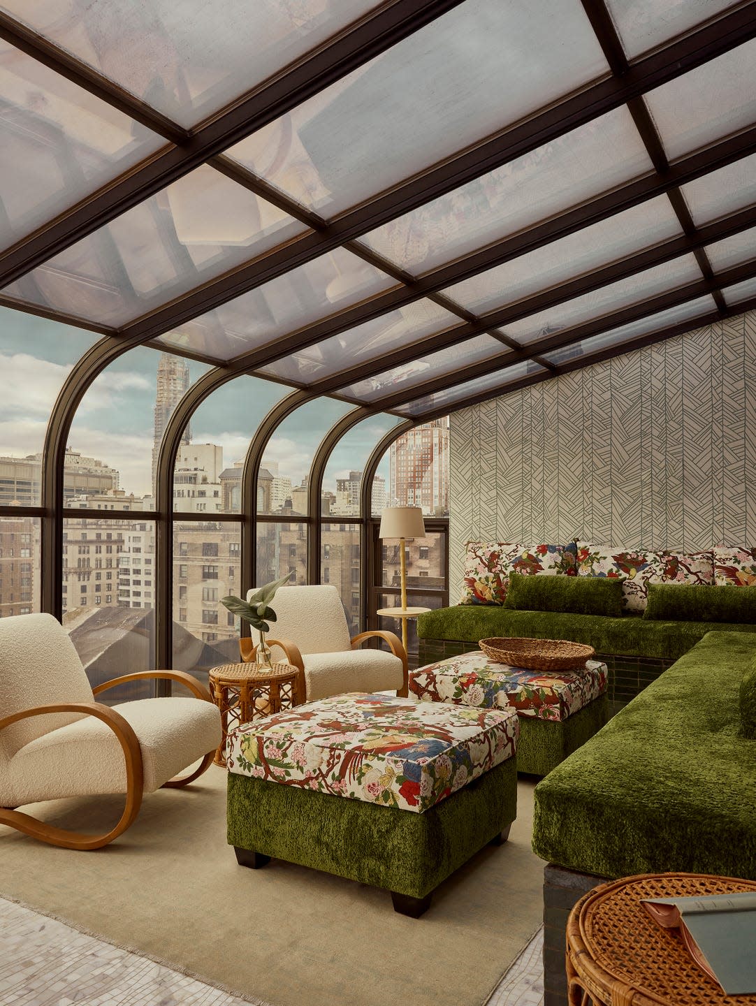 Cozy indoor lounge area with unique furniture and city view.