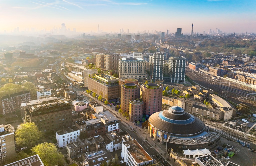Illustration of the Camden Goods Yard development in London, featuring modern buildings, green roofs, and the Roundhouse.