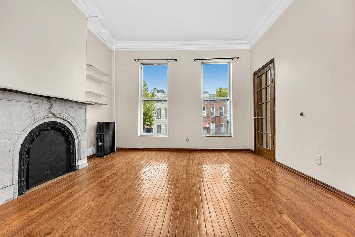 parlor with marble mantel, wood floor