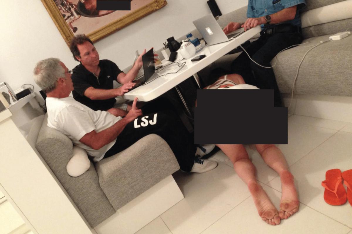 Disturbing photo shows Epstein and pals sitting unfazed as woman crawls under table with picture of naked baby nearby
