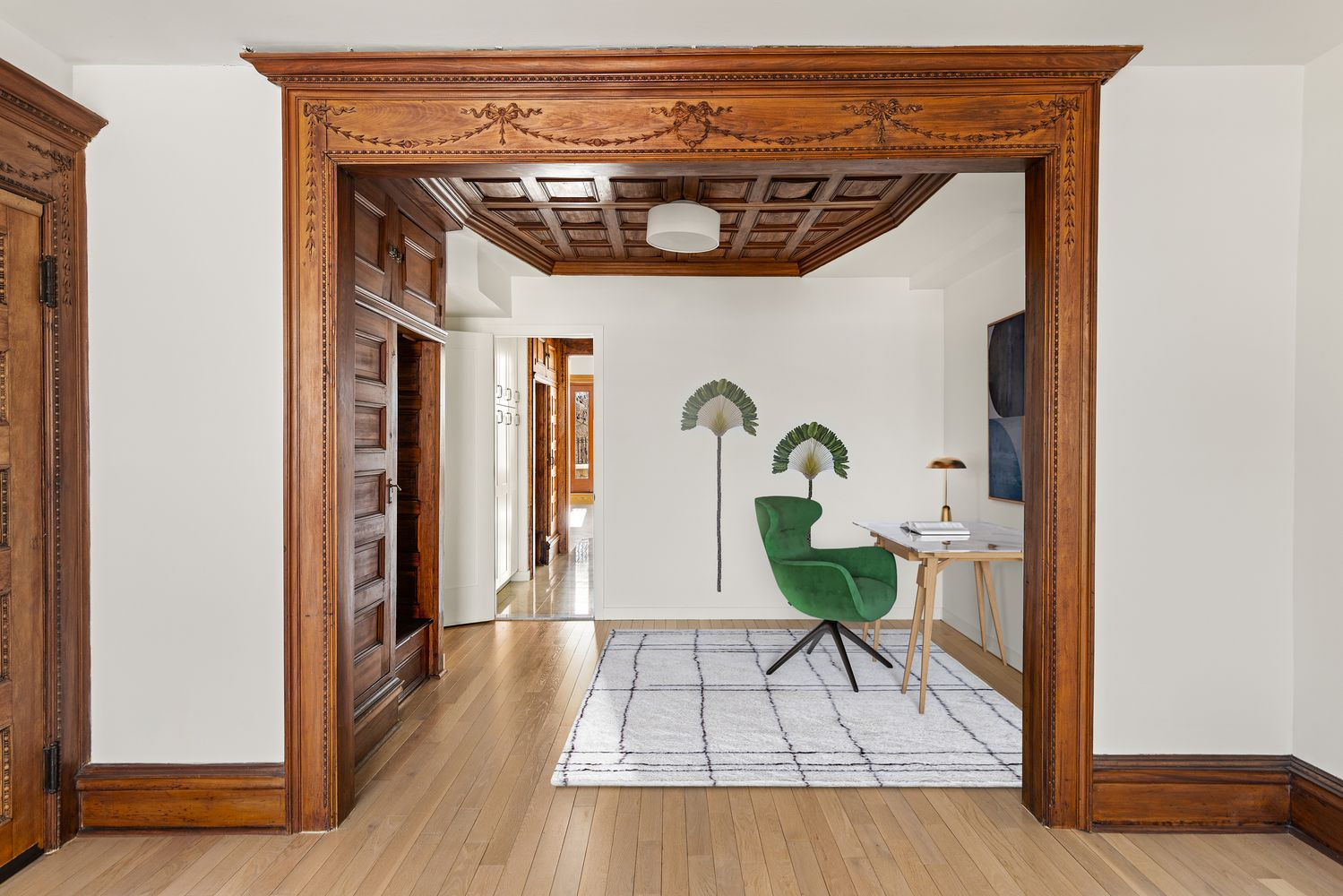 middle parlor with a coffered ceiling, built-ins set up as an office