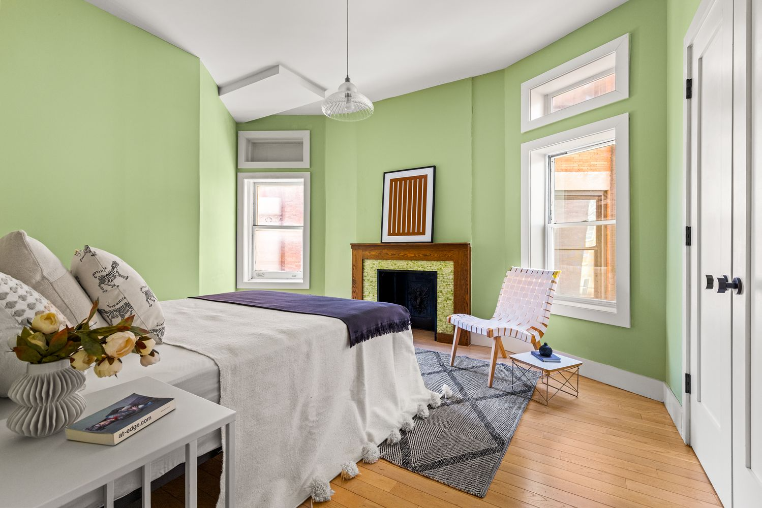 bedroom with green walls, a mantel with green tiles