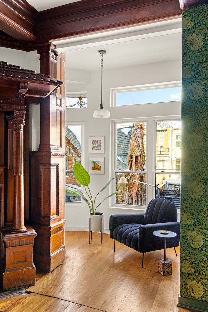 view into parlor level sunroom with wood floor, white walls