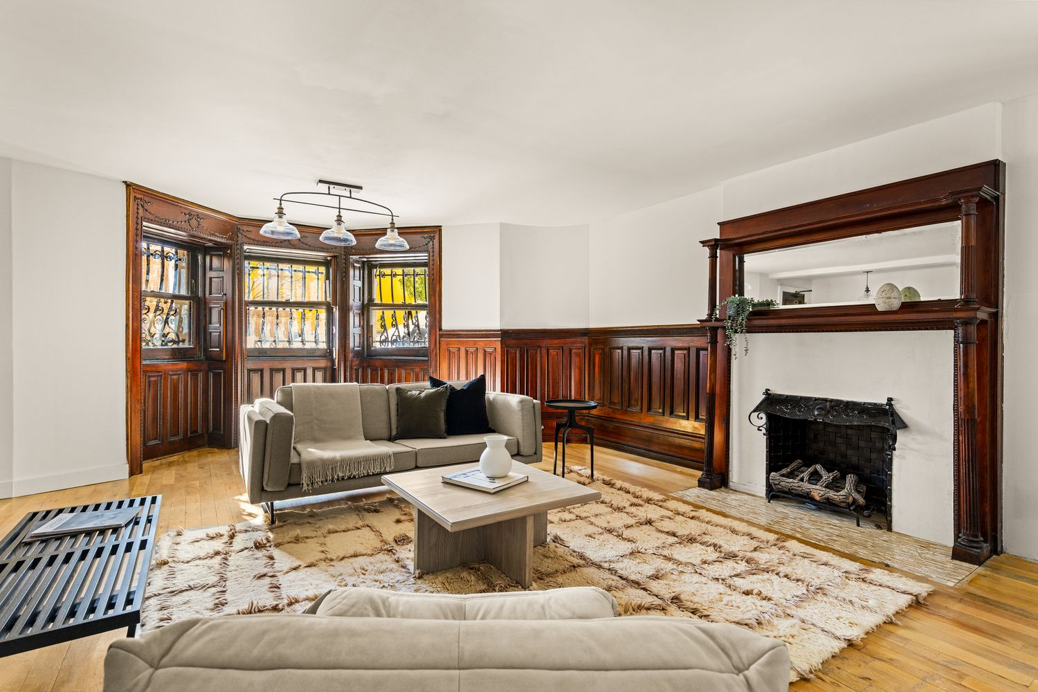 garden level dining room set up as a living room with wainscoting, mantel