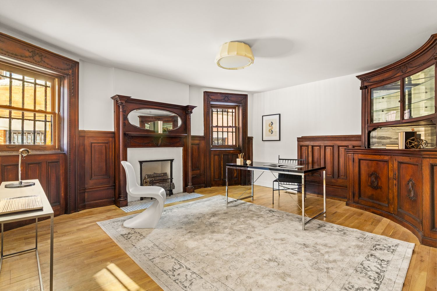 bedroom set up as an office with wainscoting, built-in
