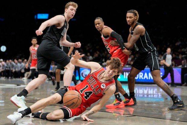 Chicago Bulls forward Matas Buzelis falls after getting fouled by Brooklyn Nets forward Danny Wolf, top left, during the second half on Monday, Feb. 9, 2026, in New York. (AP Photo/Yuki Iwamura)