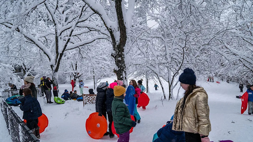 <div>NEW YORK, NEW YORK - FEBRUARY 23: Children on a snow day from school use their plastic saucers and sleds on a hill on February 23, 2026 in the Brooklyn borough of New York City. The northeast U.S. experienced a nor'easter that brought blizzard conditions, heavy snow, and strong winds. (Photo by Robert Nickelsberg/Getty Images)</div>