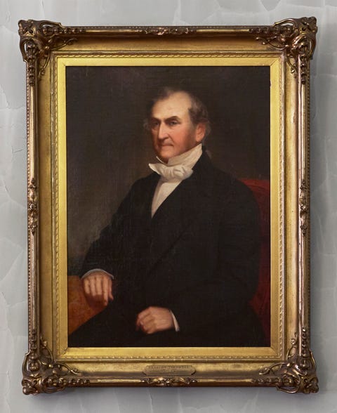 formal portrait of a man in a suit with a bow tie framed