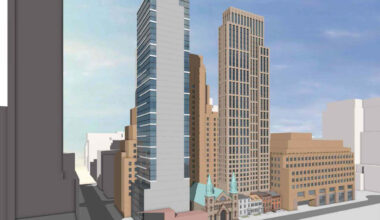 a tower behind historic houses