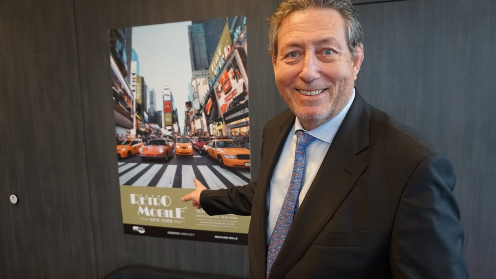 man pointing at a poster of new york city