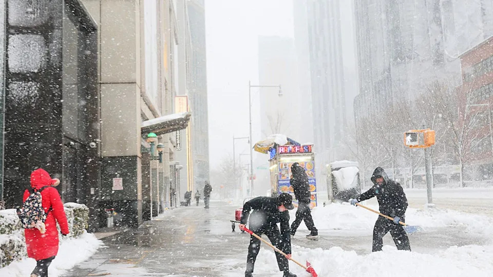 <div>NEW YORK, NEW YORK - FEBRUARY 23: People shovel snow off a sidewalk on Flatbush Avenue during a blizzard on February 23, 2026 in Downtown Brooklyn in New York City. The northeast U.S. is bracing for an intense nor'easter with blizzard conditions, heavy snow, and strong winds. New York City Mayor Zohran Mamdani announced a state of emergency for NYC and issued a travel ban beginning at 9 p.m. tonight, and ending at 12 p.m. on Monday. NYC could get more than a foot of snow with up to two feet on Long Island and in parts of New Jersey. (Photo by Michael M. Santiago/Getty Images)</div>