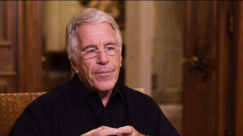 Jeffrey Epstein wearing glasses and a black shirt.