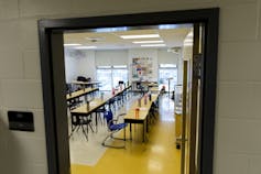 a classroom seen through a doorway.