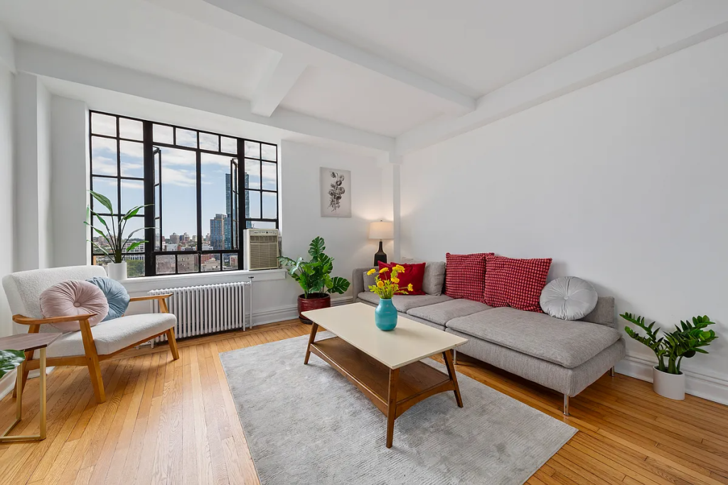 a fort greene studio with white walls and a wood floor