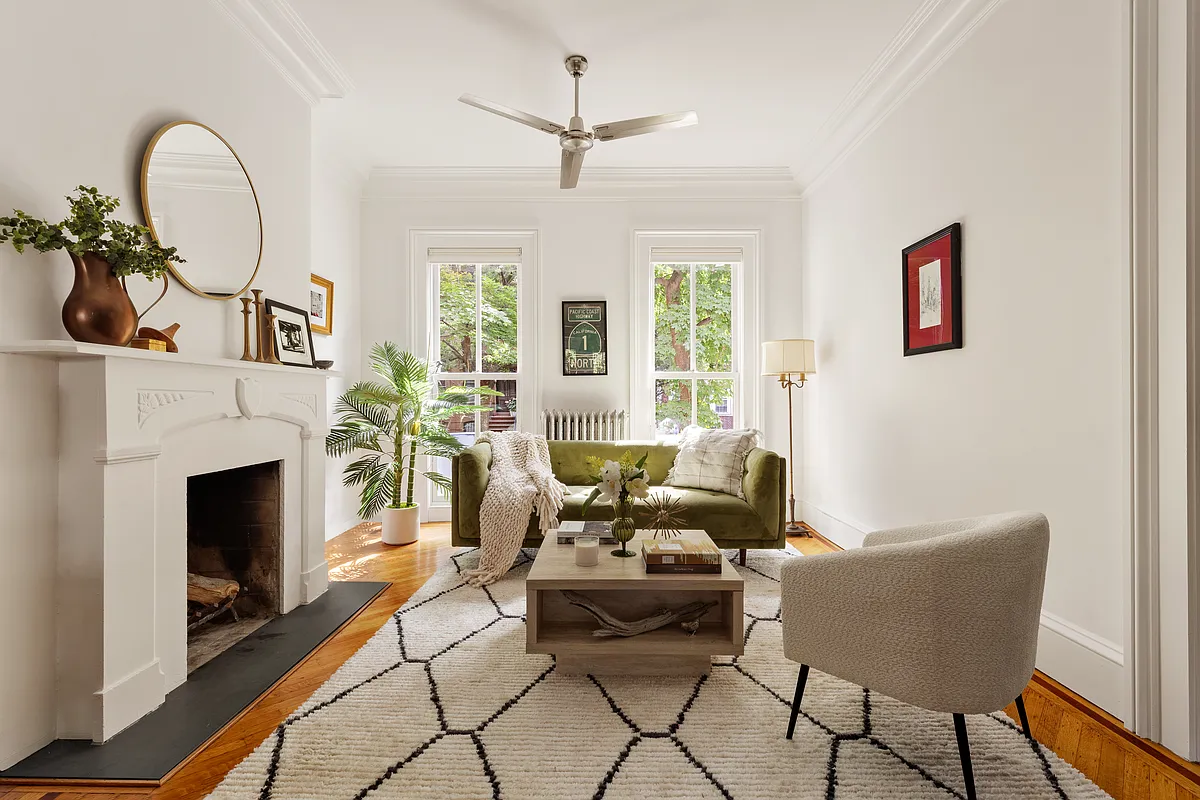 front parlor with white walls, white painted mantel, wood floor