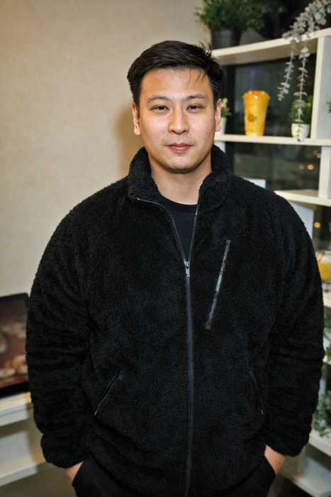 Richard Guo, owner of the Astoria Mango Mango location, stands inside the dessert café he opened with his wife.
