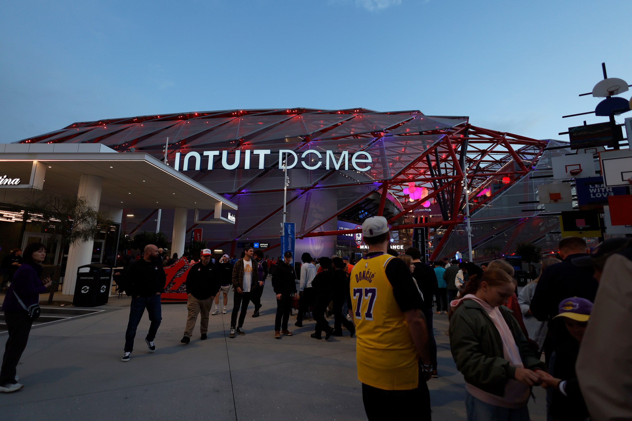 INGLEWOOD, CALIFORNIA - JANUARY 22: Fans walk outside of Intuit Dome before a game between the Los Angeles Lakers and the Los Angeles Clippers on January 22, 2026 in Inglewood, California. NOTE TO USER: User expressly acknowledges and agrees that, by downloading and or using this photograph, User is consenting to the terms and conditions of the Getty Images License Agreement. (Photo by Ronald Martinez/Getty Images)