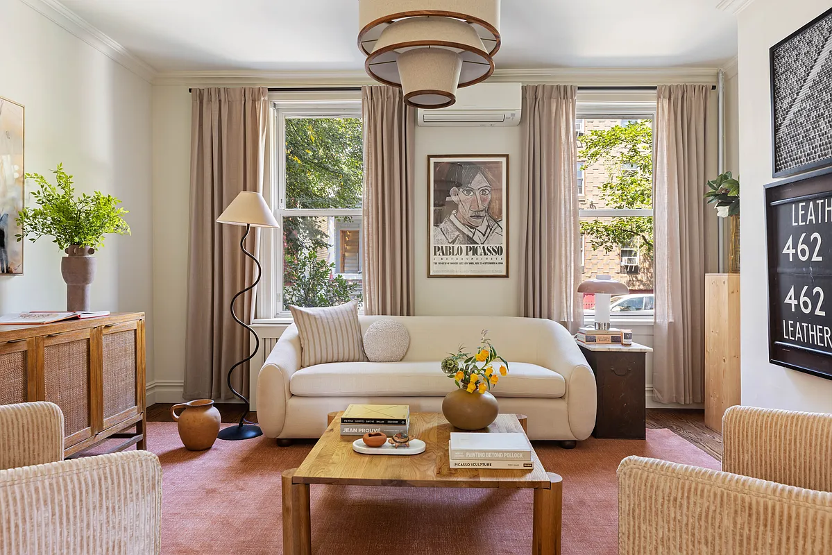 living room with two windows, wood floor, mini split on wall