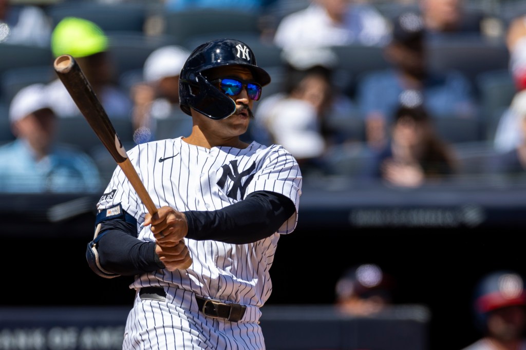 New York Yankees outfielder Trent Grisham (12) hits a solo home run.