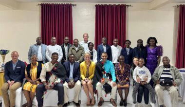 Members of NYRR's Executive Leadership and Professional Athletes Team with Toby Tanser and past Kenyan New York City Marathon champions in February 2026.