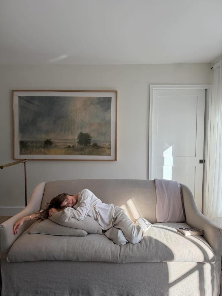 Olivia Jade cuddles up on the couch. 