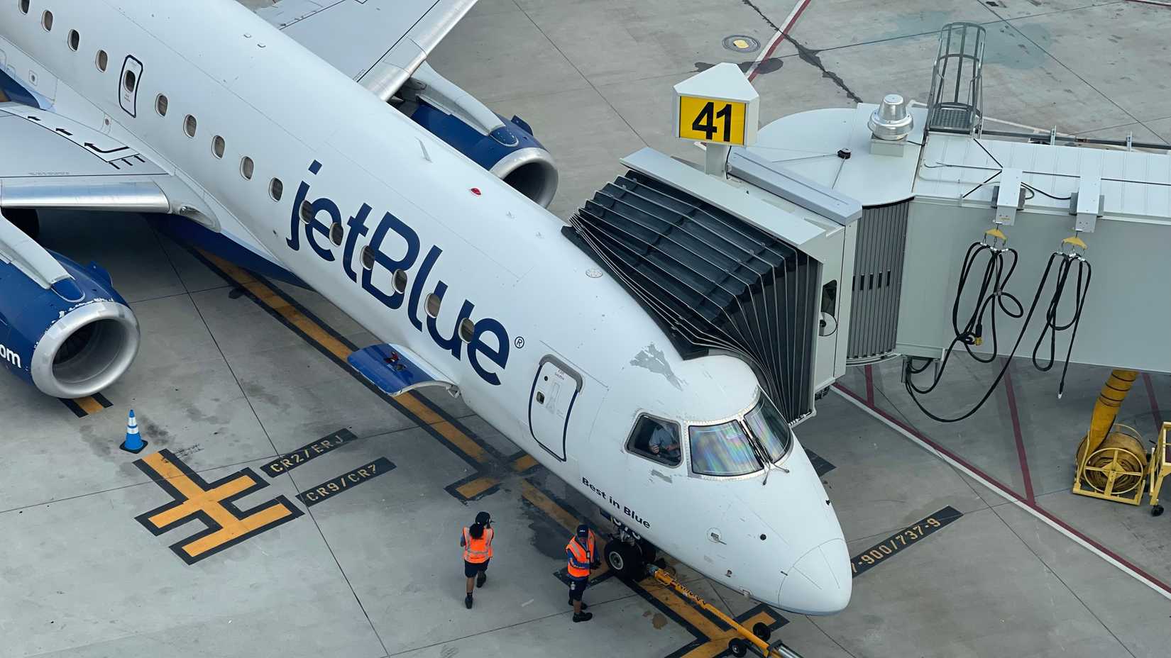 JetBlue Embraer E190 at the gate at New York LaGuardia Airport LGA shutterstock_2512795829
