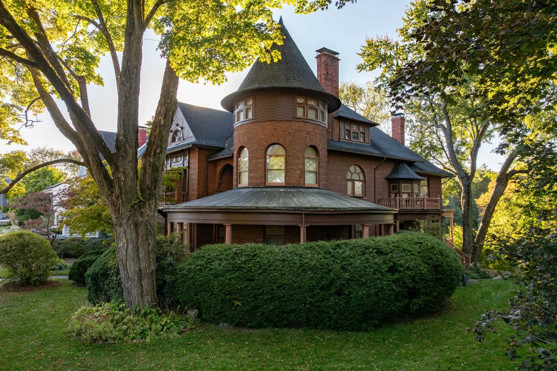 brick house with porches, tower, chimneys