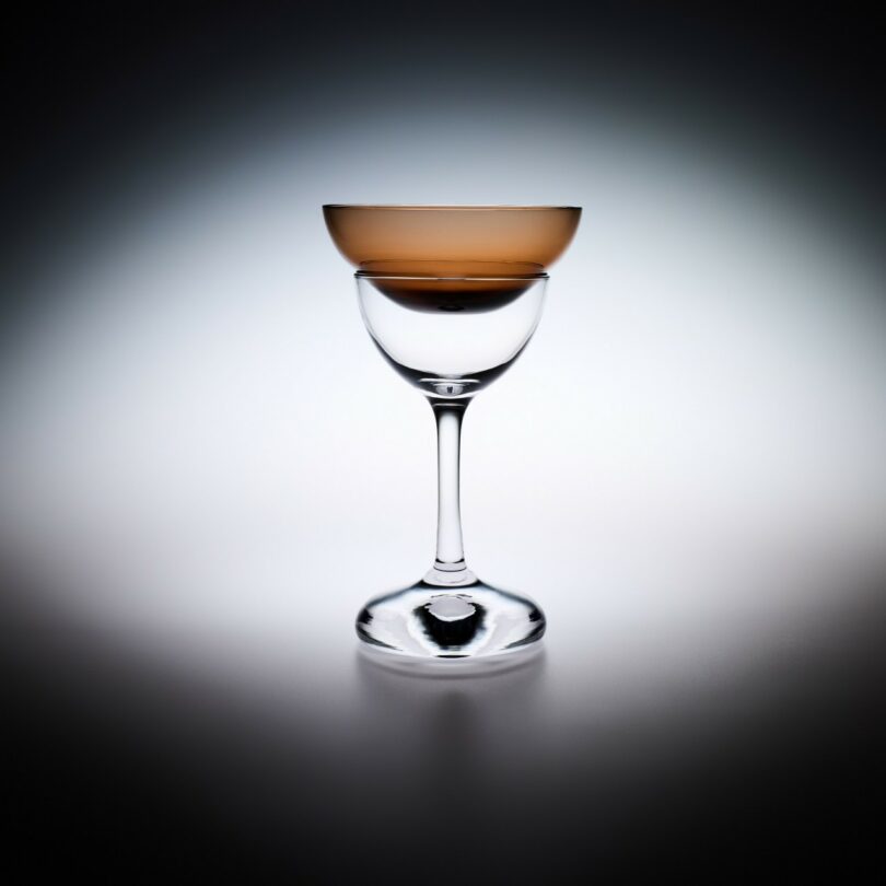 A glass with a couple of colored cups