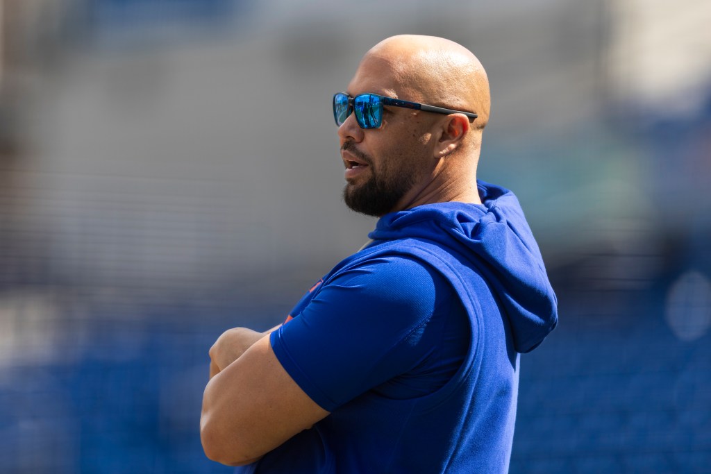 Carlos Beltran, special assistant to the New York Mets president of baseball operations, wearing a blue sleeveless hoodie and blue sunglasses.