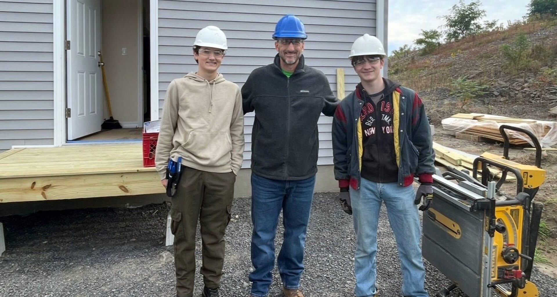 Saugerties counselor Michael Catalano with Ulster BOCES students at a Habitat for Humanity building site. 