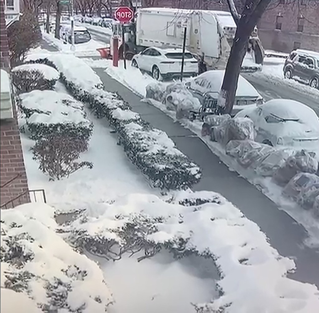 snow covered cars and sidewalk