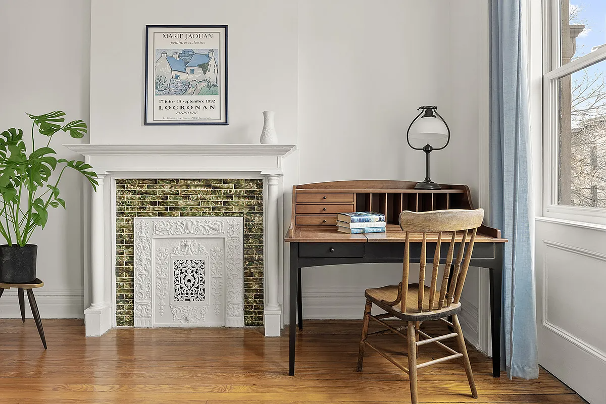 bedroom with columned mantel painted white