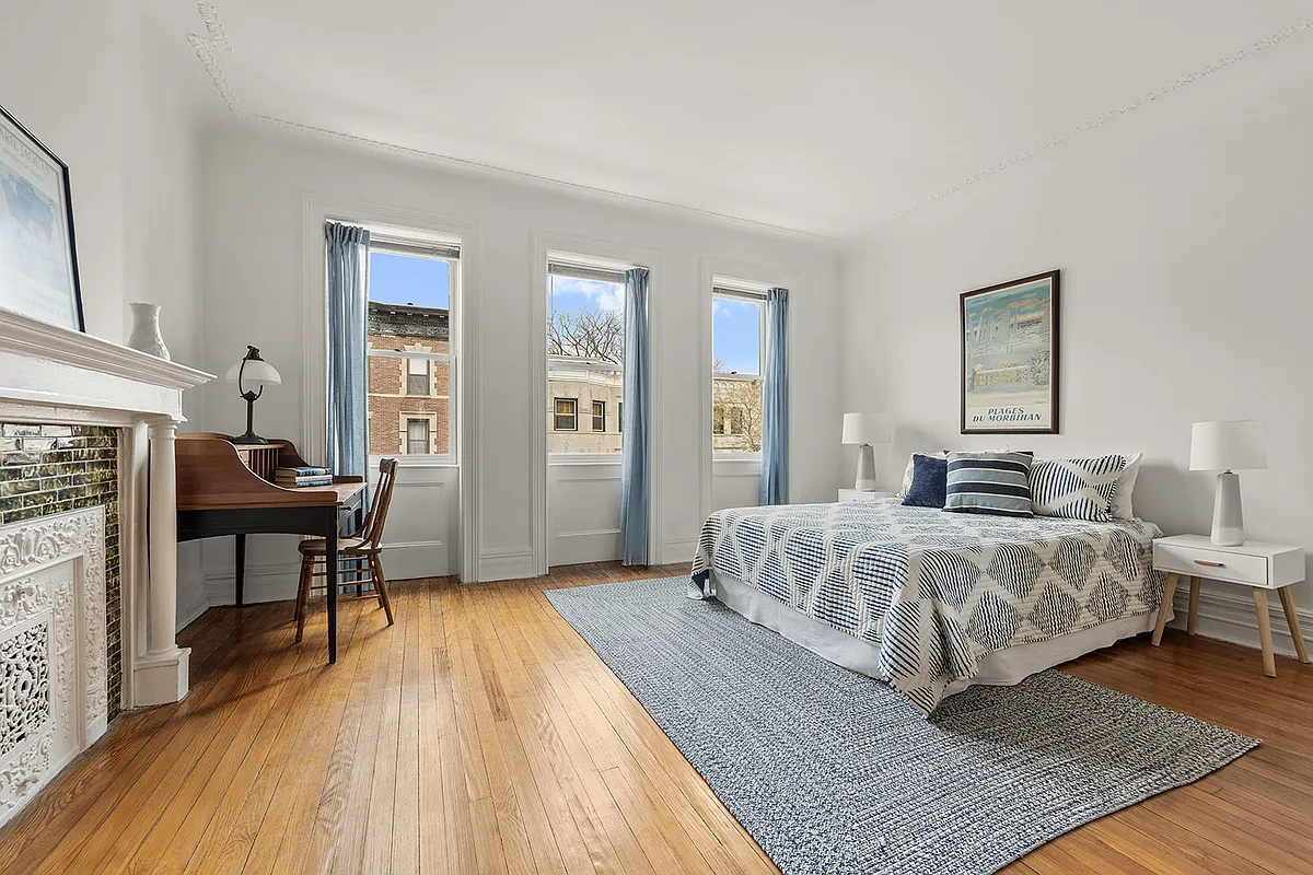 bedroom with white columned mantel