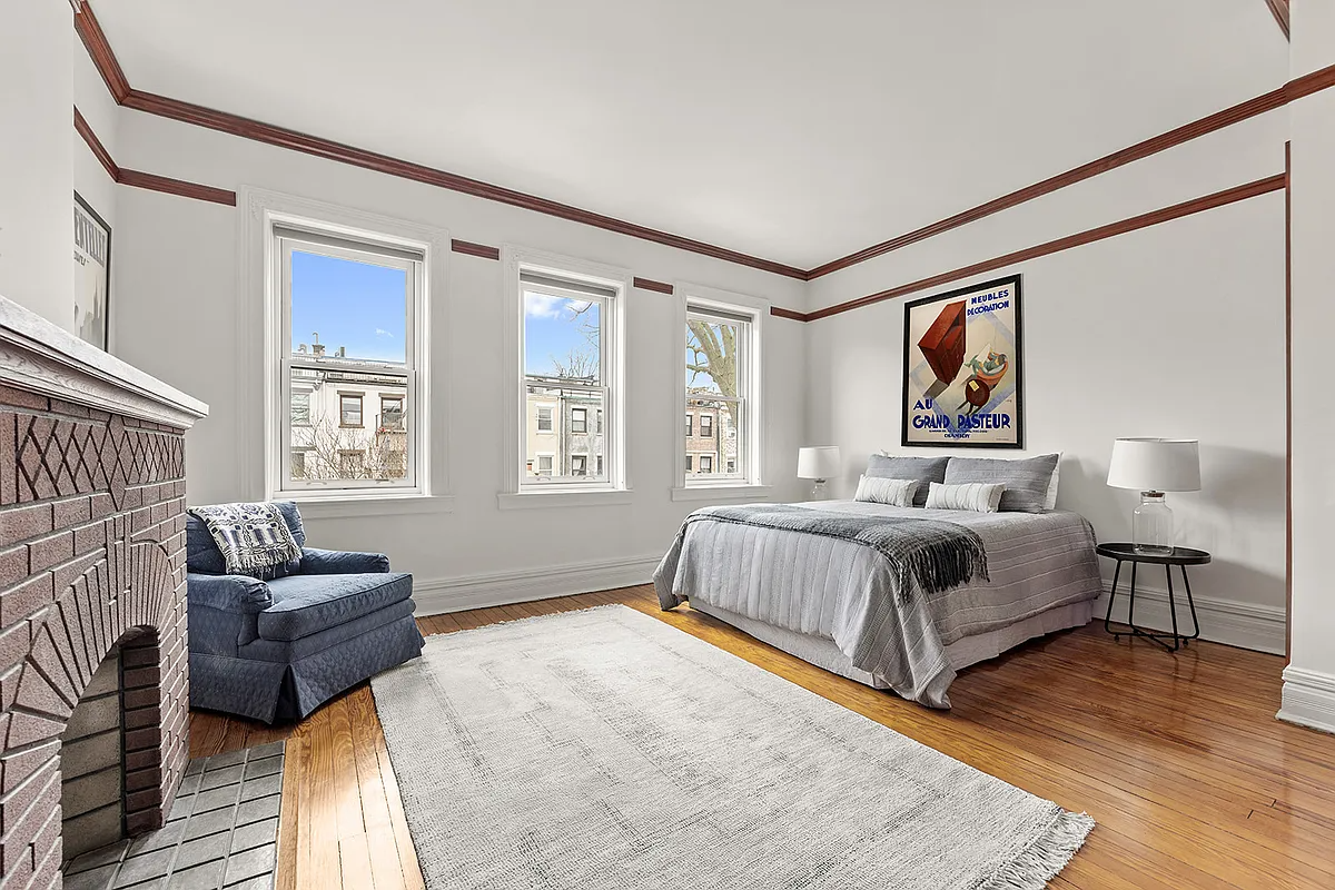 bedroom with brick mantel
