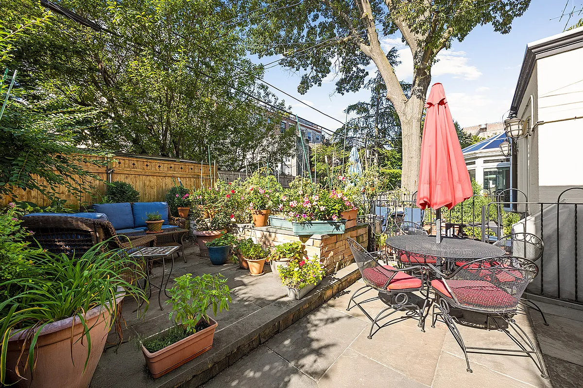 paved rear yard with room for seating, planters