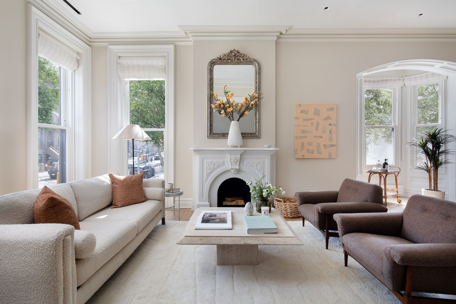 parlor with cream walls, moldings, two exposures, a mantel