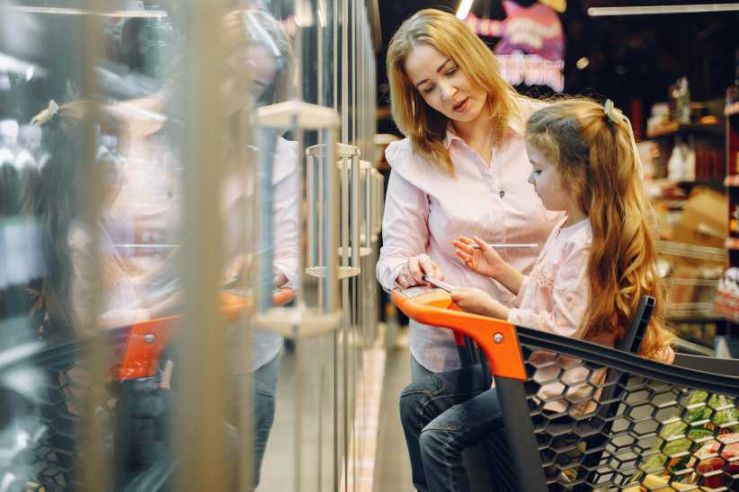 Mom and daughter shopping in supermarket