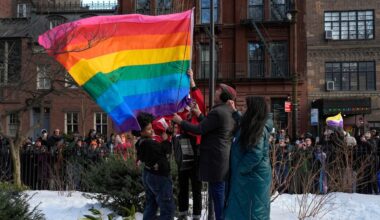 New York politicians and activists raise a rainbow flag on a pole in Christopher Park across the street from the Stonewall Inn, Thursday, Feb. 12, 2026, in New York, a few days after it was removed by the National Park Service to comply with guidance from the Trump administration. (AP Photo/Yuki Iwamura)